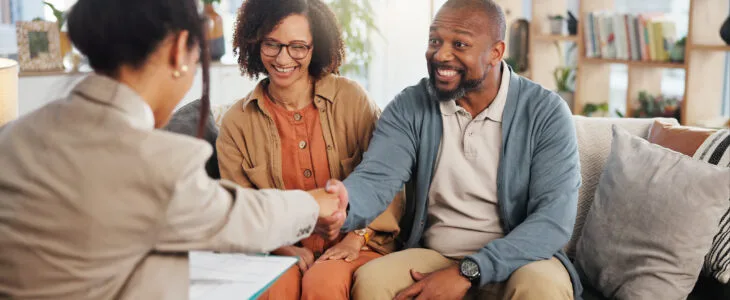Financial advisor, handshake and mature couple and deal for estate planning, asset management or pension. Documents, life insurance and paperwork with people at home for investment portfolio